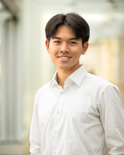 A color photo of a man smiling for a photo.