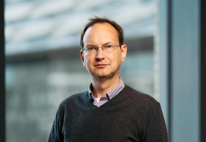 David Mimno stands in front of a window at Gates Gall
